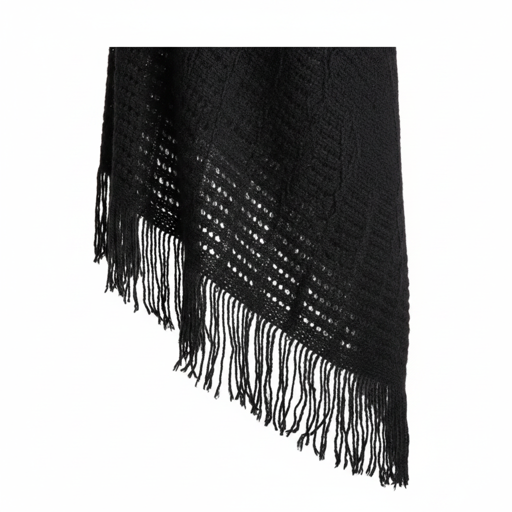 Women's black ruana wrap close-up, ladder-stitch knit texture and frayed fringe trim detail