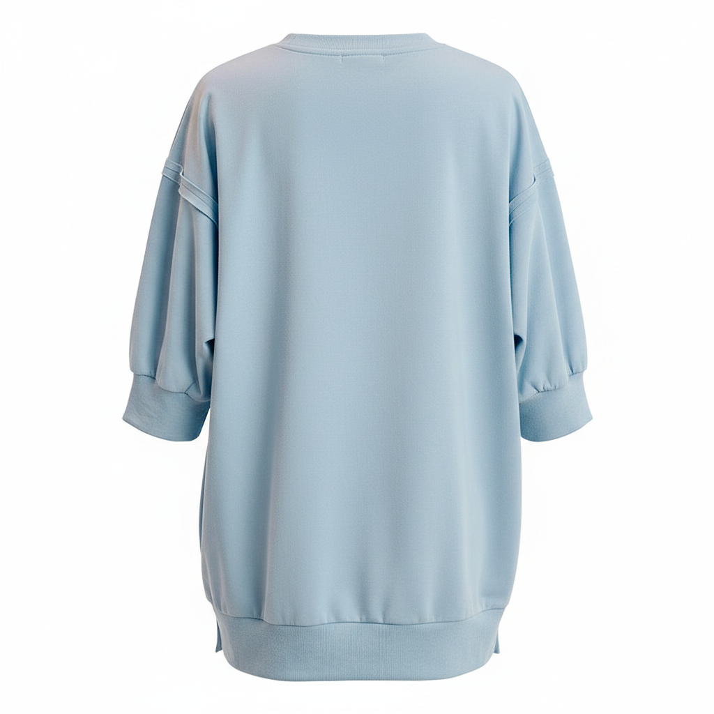 Women's light blue French terry pullover top back view, drop shoulder seam, relaxed boxy silhouette, side slit hem
