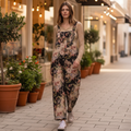 Bluevelvet black floral print overalls walking on a boutique sidewalk, wide-leg silhouette