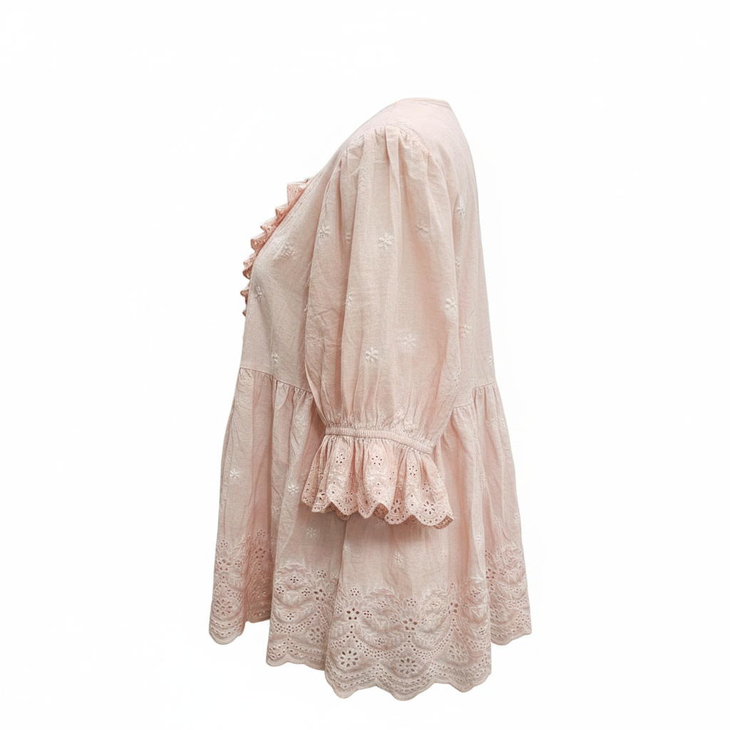 Women's blush pink eyelet cotton blouse side view, puffed sleeves, peplum silhouette, relaxed fit