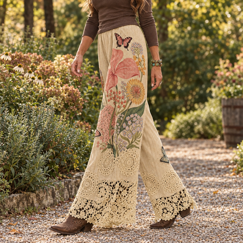 A Rare Bird Shop women's beige floral wide-leg pants with crochet hems on a garden walk