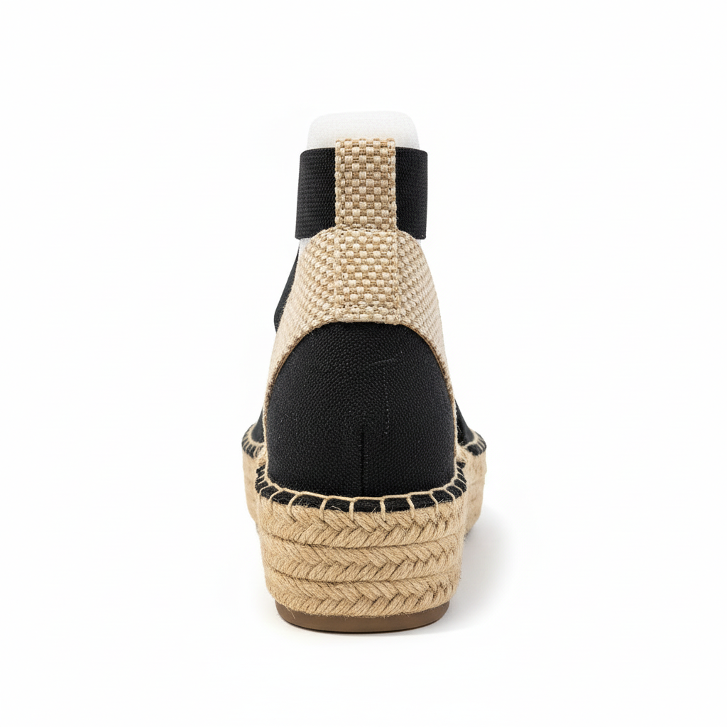 Back view of black canvas espadrille showing heel area and beige ankle strap closure