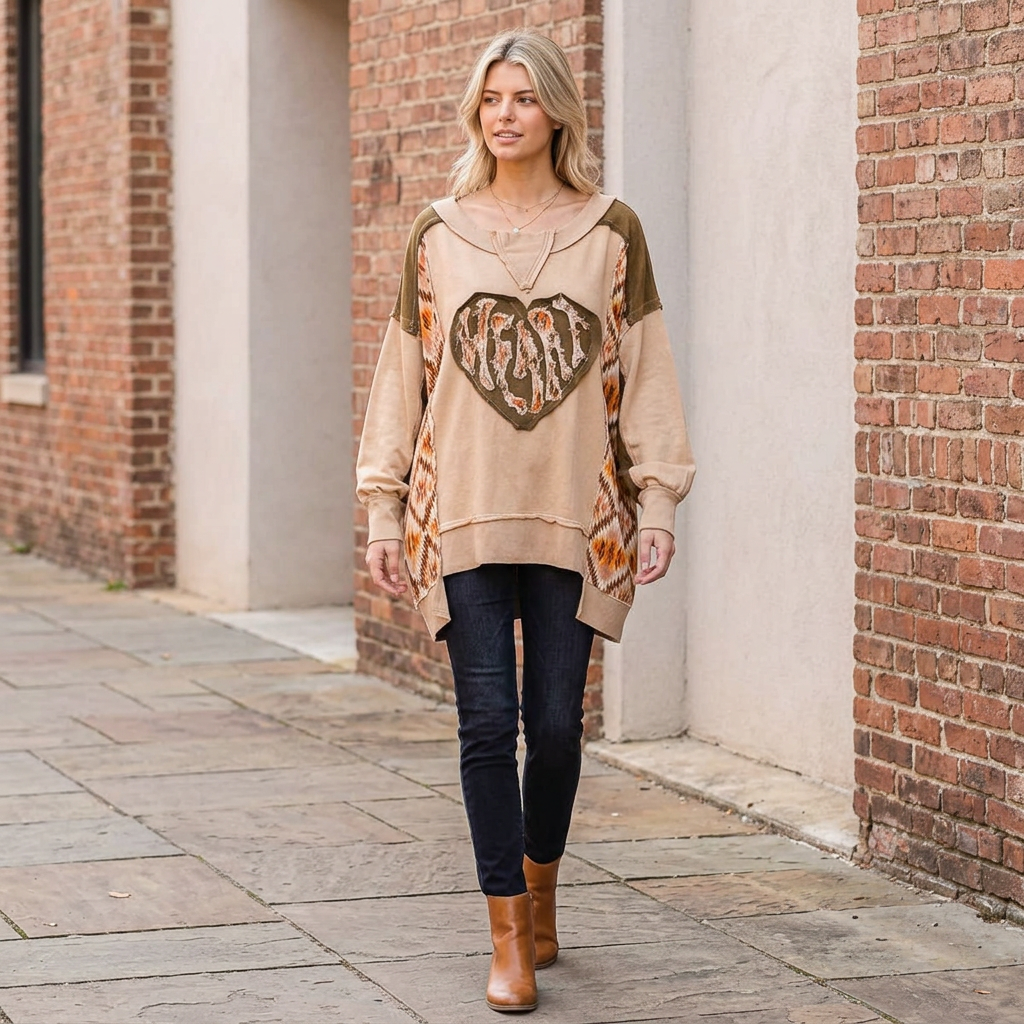 Coffee heart patchwork pullover styled with dark jeans and tan boots on a brick-lined walkway