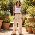 POL Clothing women's cream multi crochet butterfly wide leg knit pants on garden patio - BellanBlue