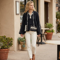 POL Clothing women's black embroidered gauze hoodie with ivory jeans outside a cafe