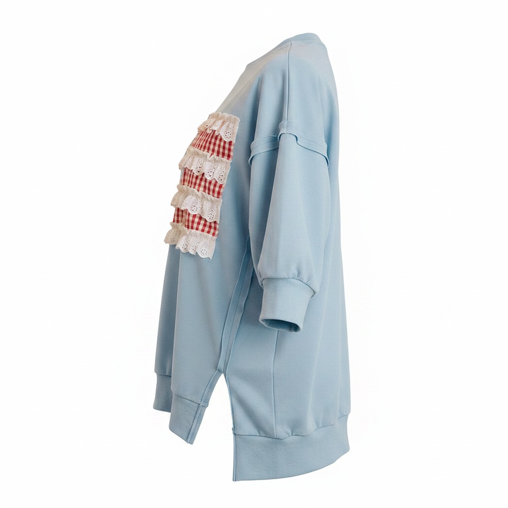 Women's light blue patchwork pullover top side profile, drop shoulder, open seam detail, side slit hem
