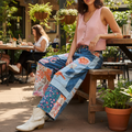 POL patchwork wide-leg denim pants in denim multi, seated outdoor brunch, white cowboy boots