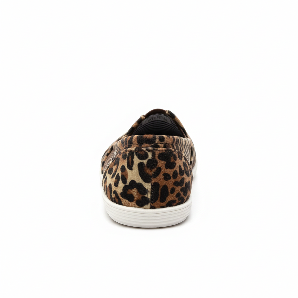 Women's leopard print canvas slip-on flat shoe, back heel view showing elastic gore, white background