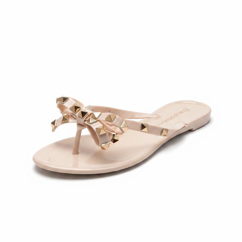 Nude blush jelly thong sandal with gold pyramid studs and bow detail, 3/4 front view - BellanBlue