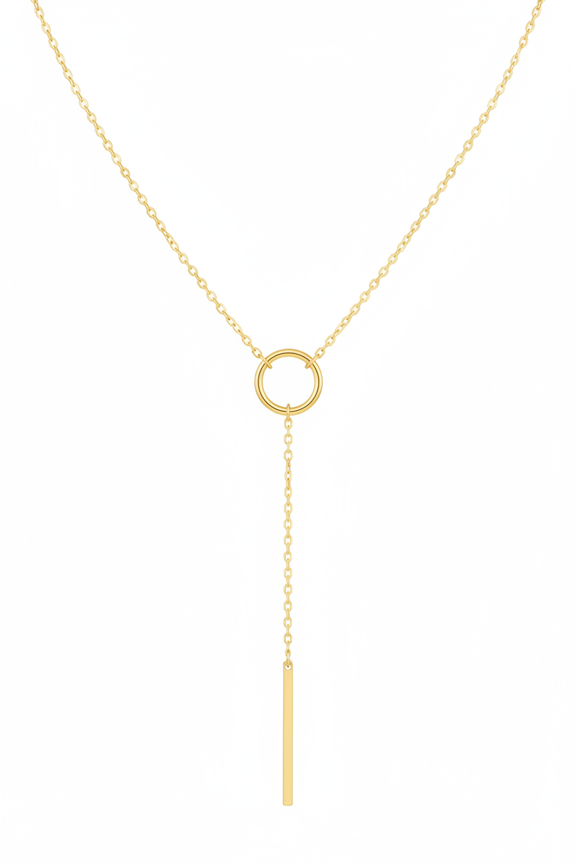Gold tone lariat necklace with circle and bar design - flat lay