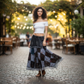 Women's black multi patchwork boho maxi skirt styled with white off-shoulder top for a relaxed café feminine outfit