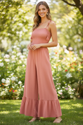 Women's coral woven smocked ruffle jumpsuit styled for a vacation or summer date night