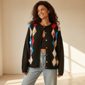 Women's black fuzzy argyle cardigan styled with jeans, 3D floral appliqué, multicolor buttons, relaxed oversized fit