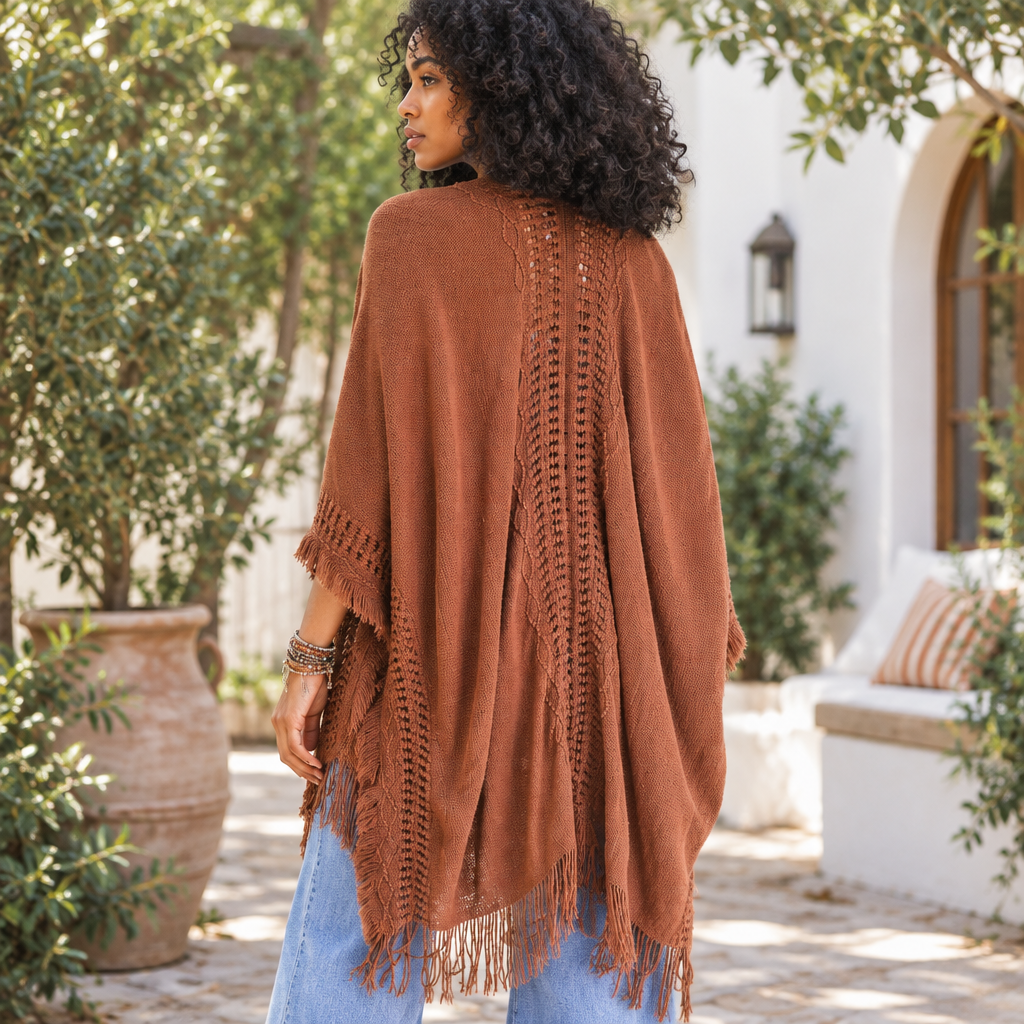 Back view of Leto Collection women's brown ruana showing its open-knit panel and fringe hem