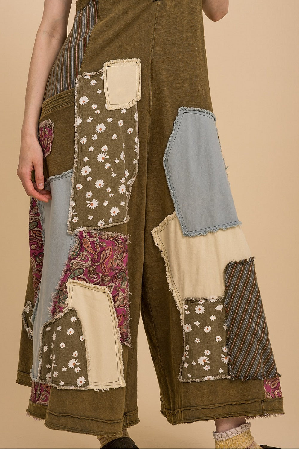 Patchwork pants with various patterns on a beige background