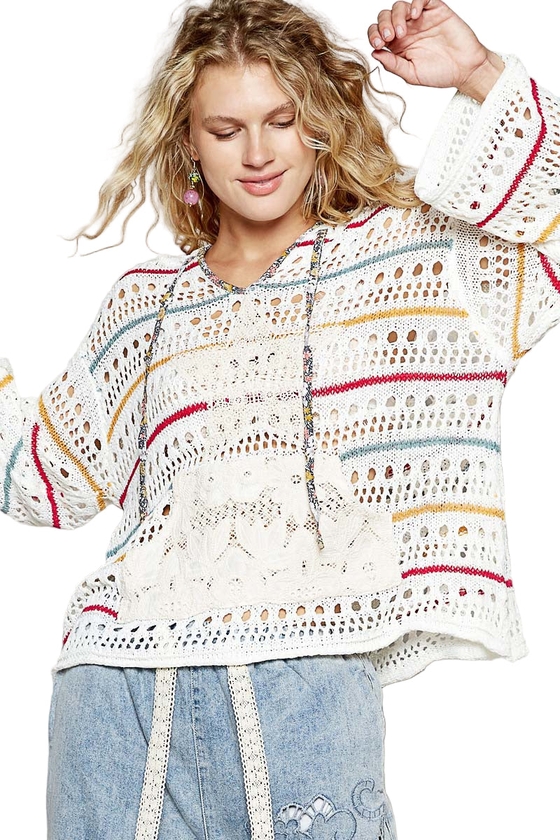Woman wearing a colorful crochet top with a white background
