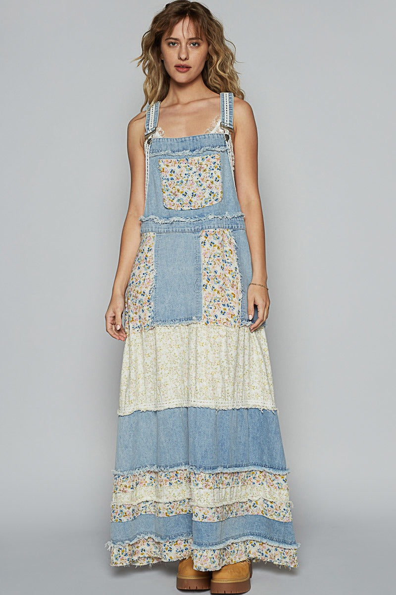 Woman wearing a patchwork dress with floral patterns on a gray background