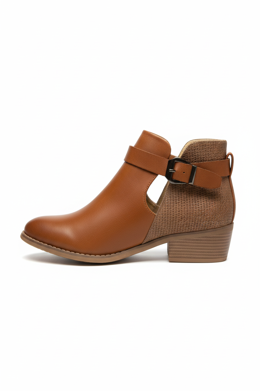 Brown ankle boot with a strap on a white background