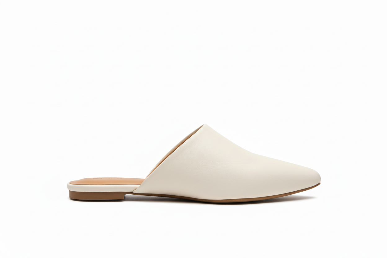 Side view of white pointed-toe mules