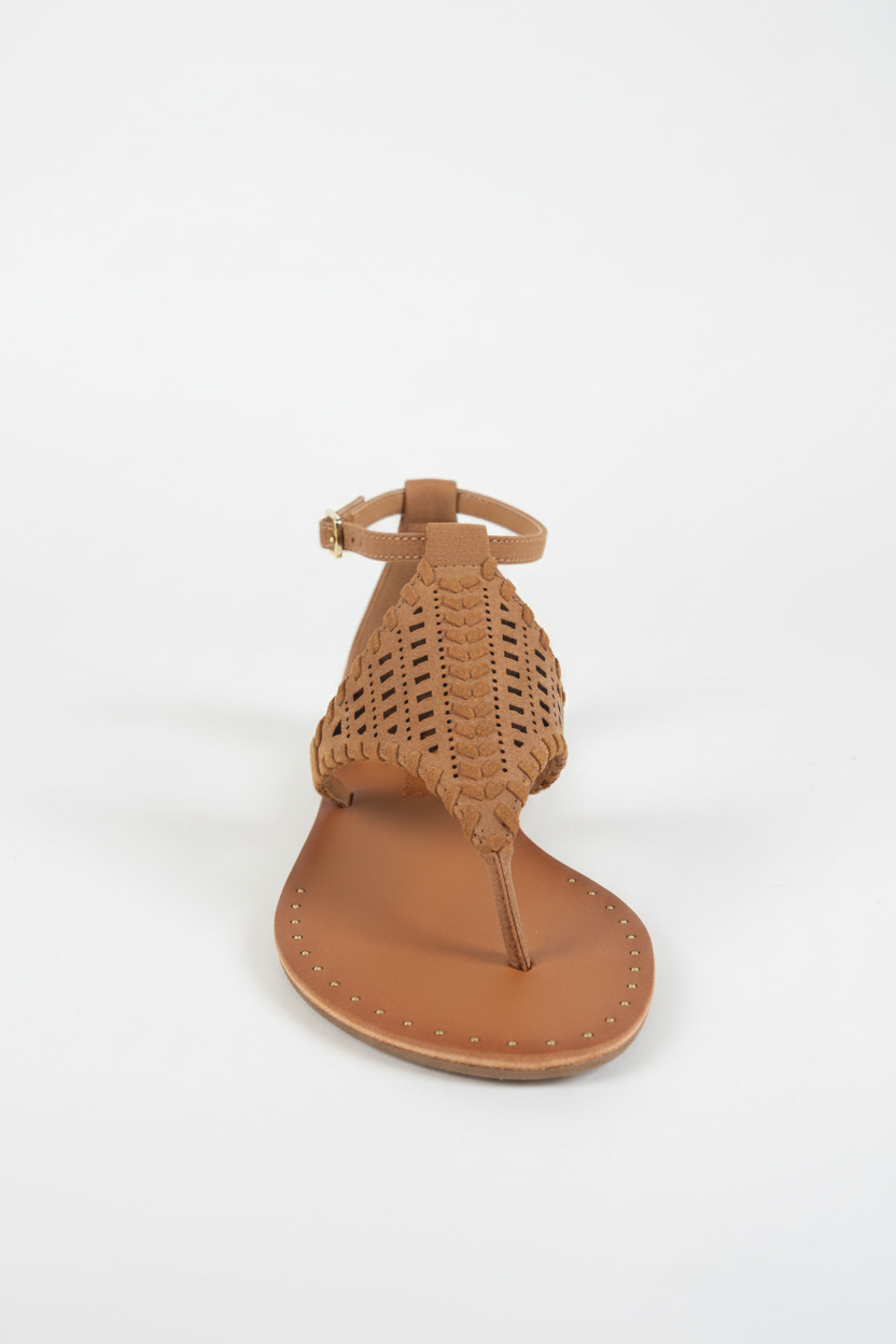 Brown sandal with woven design on a white background