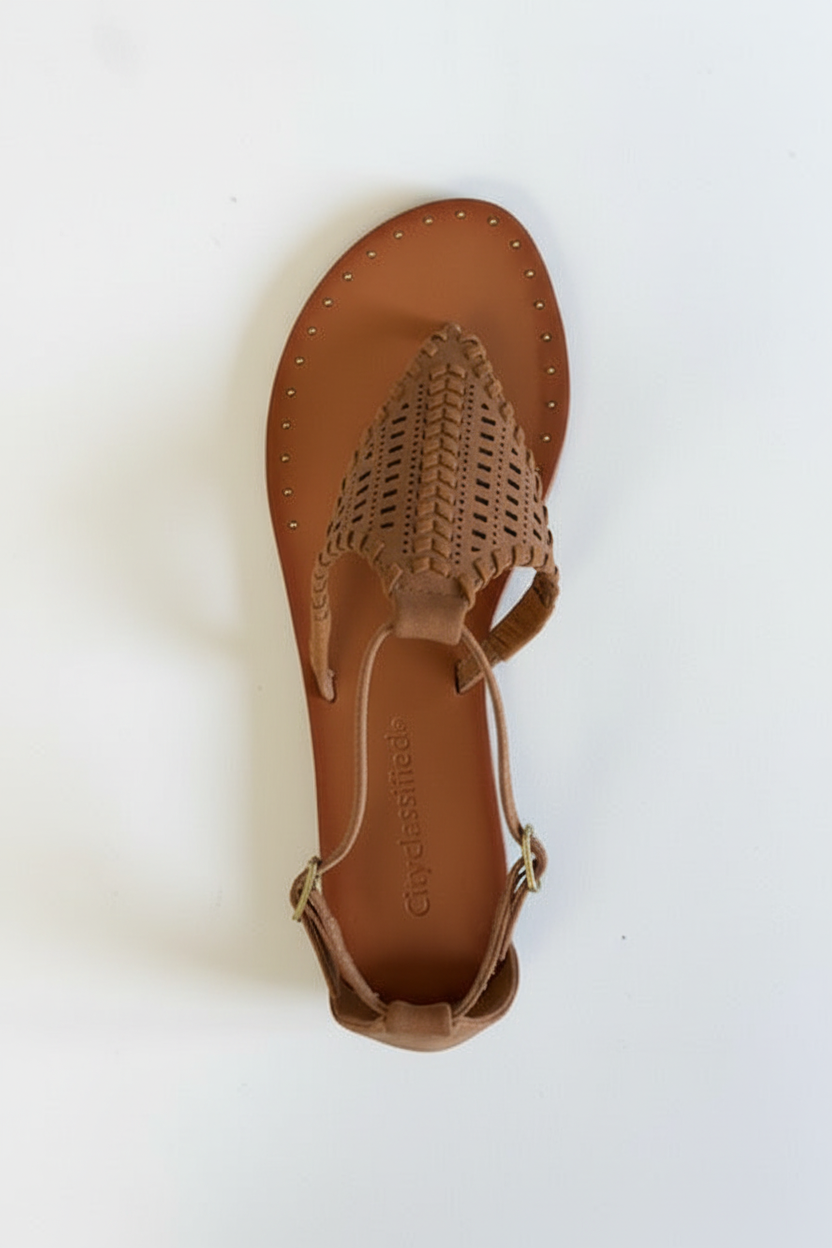 Brown sandal with open-toe design on a white background