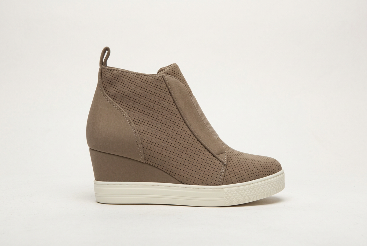 A single wedge ankle boot in taupe brown with perforated side panels and a thick off-white platform sole, shown from a side profile on a light gray background.