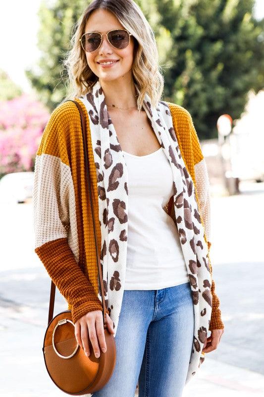 Be fierce in our Animal Print Color Block Knit Cardigan. With its eye-catching color block design and wild animal print accents, this piece will surely make a statement! 