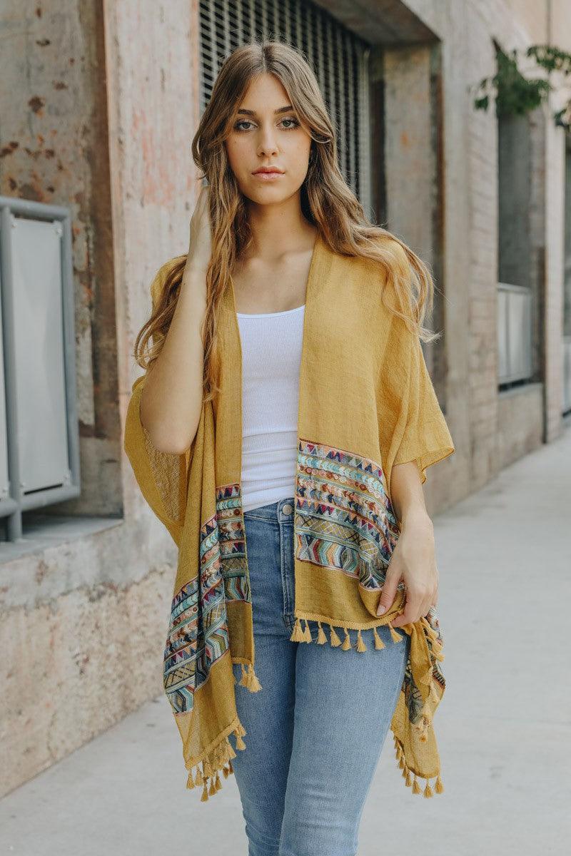 Ladies, up your outfit game with this amazing tassel Kimono! Whether you're rockin' a basic t-shirt and jeans or need some shoulder warmth over a dress, this soft and comfy piece will leave everyone complimenting your style.